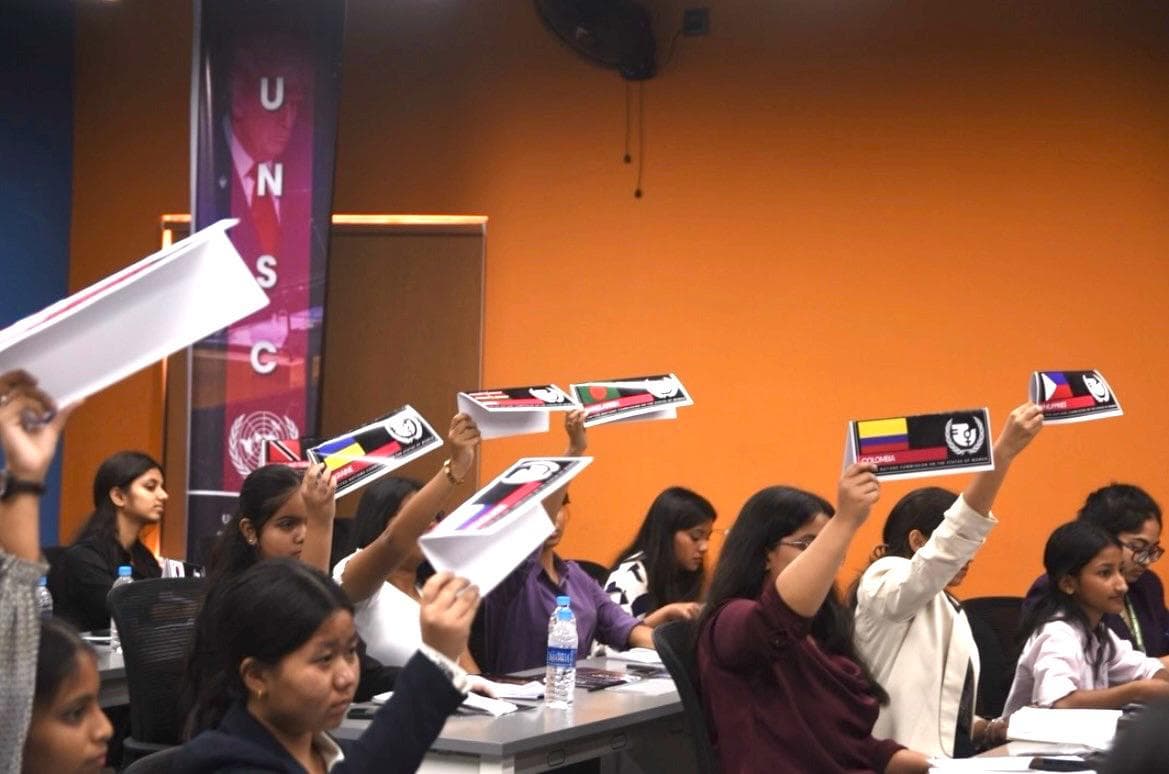Students raising country placards at a NEXIS event