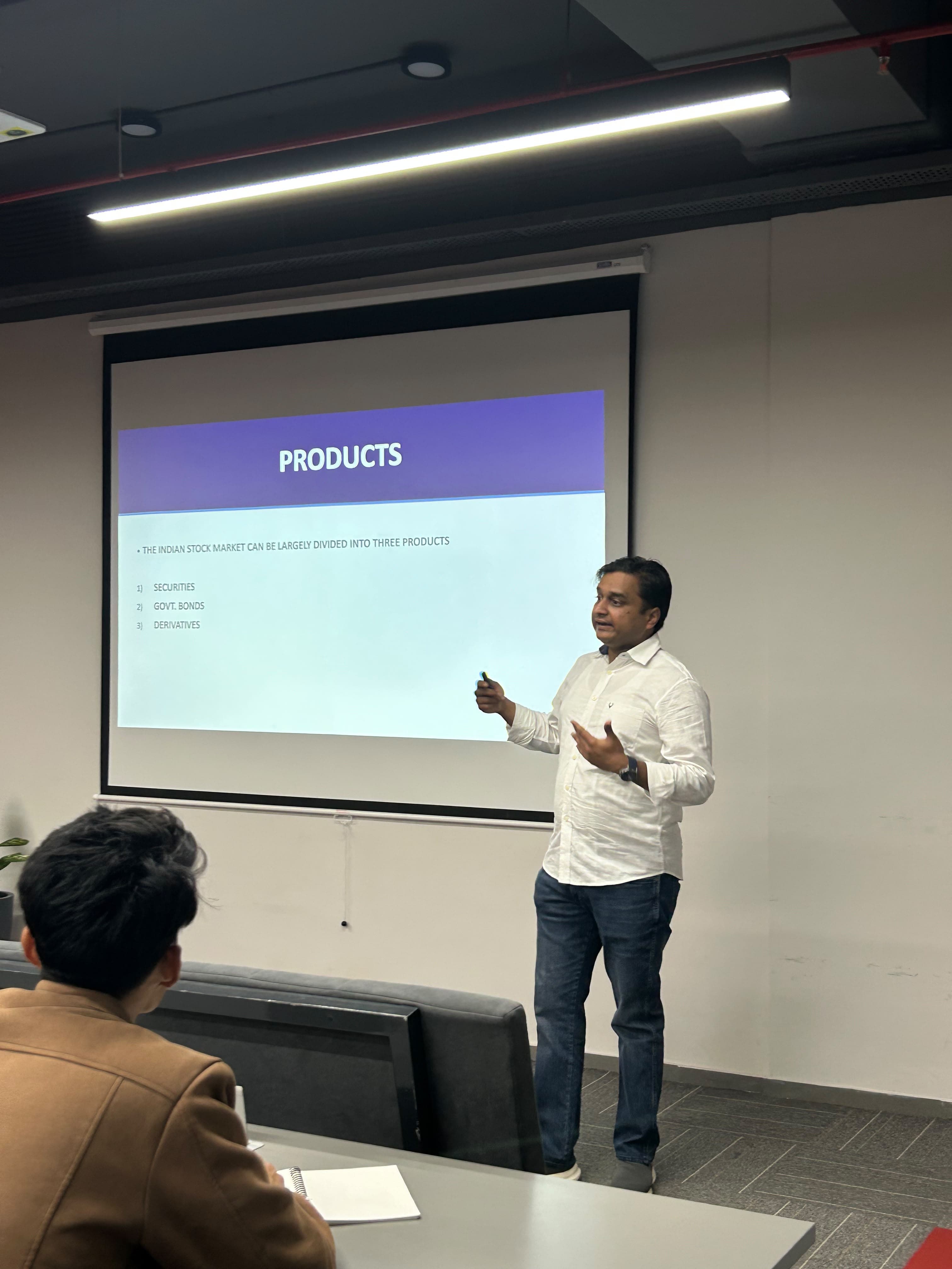 A speaker explaining financial products during a NEXIS masterclass